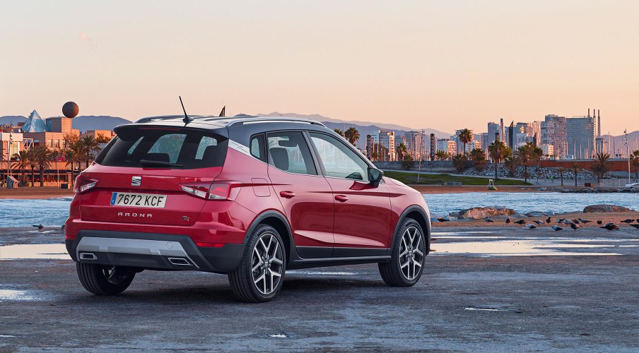 SEAT Arona parked in front of the sea and the city