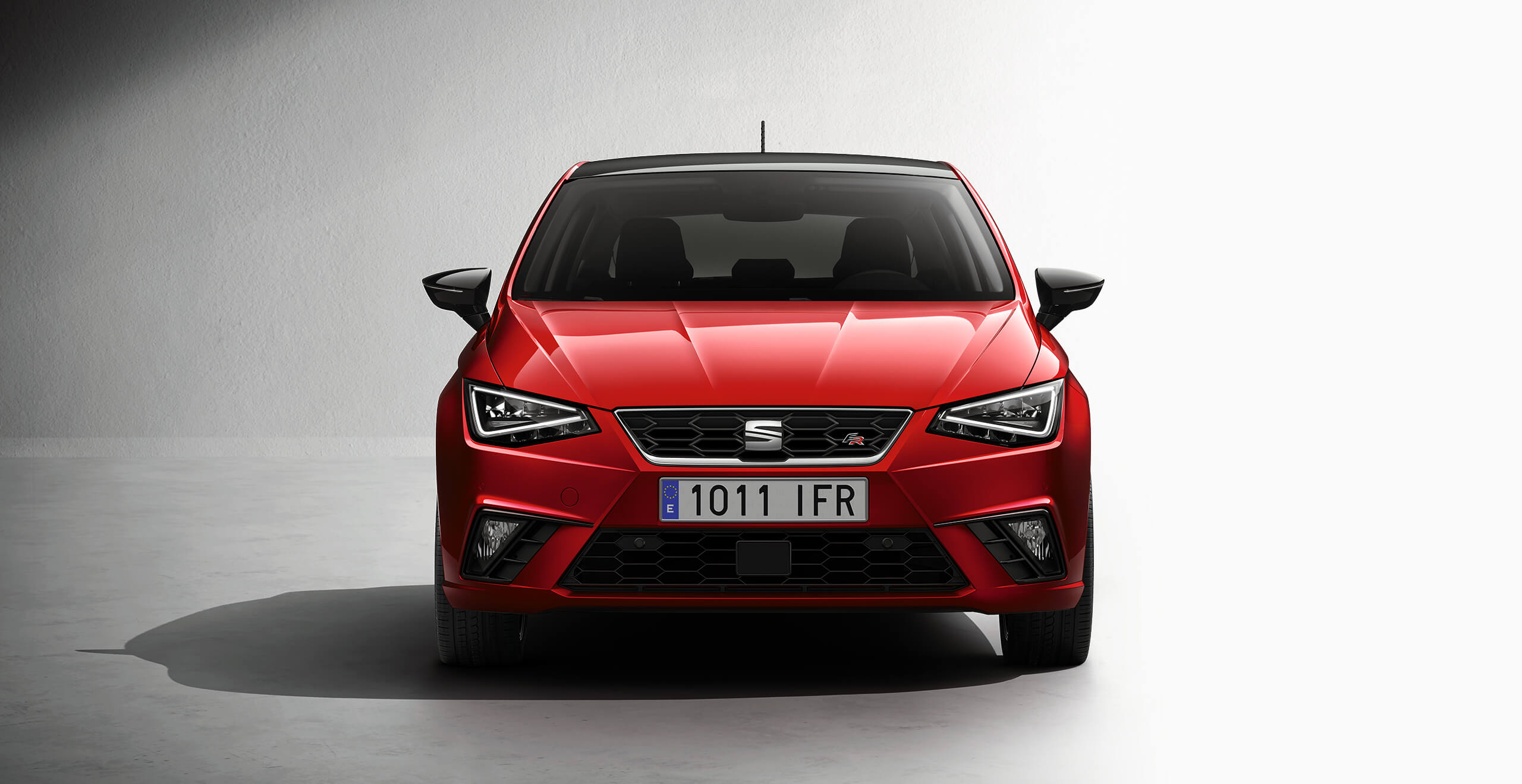 Shows a desire red 2018 SEAT Ibiza car model, its car side exterior view that reduce carbon emissions and performs a better car efficiency