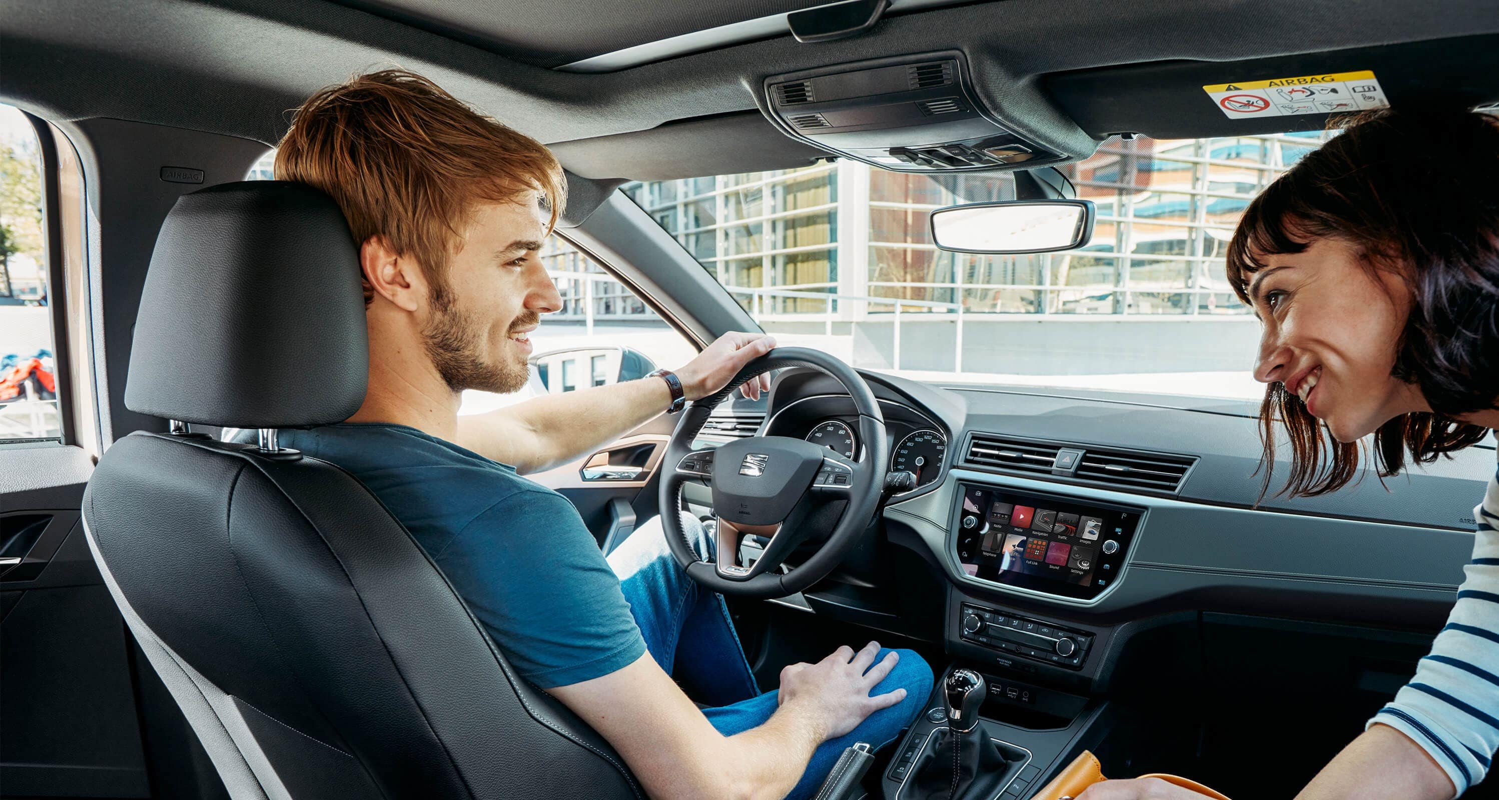 SEAT Ibiza Xcellence 2018 detailed interior technology. Interior front car image with men and woman