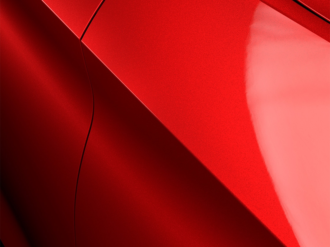 SEAT Leon in desire red with a special metallic finish, close up.