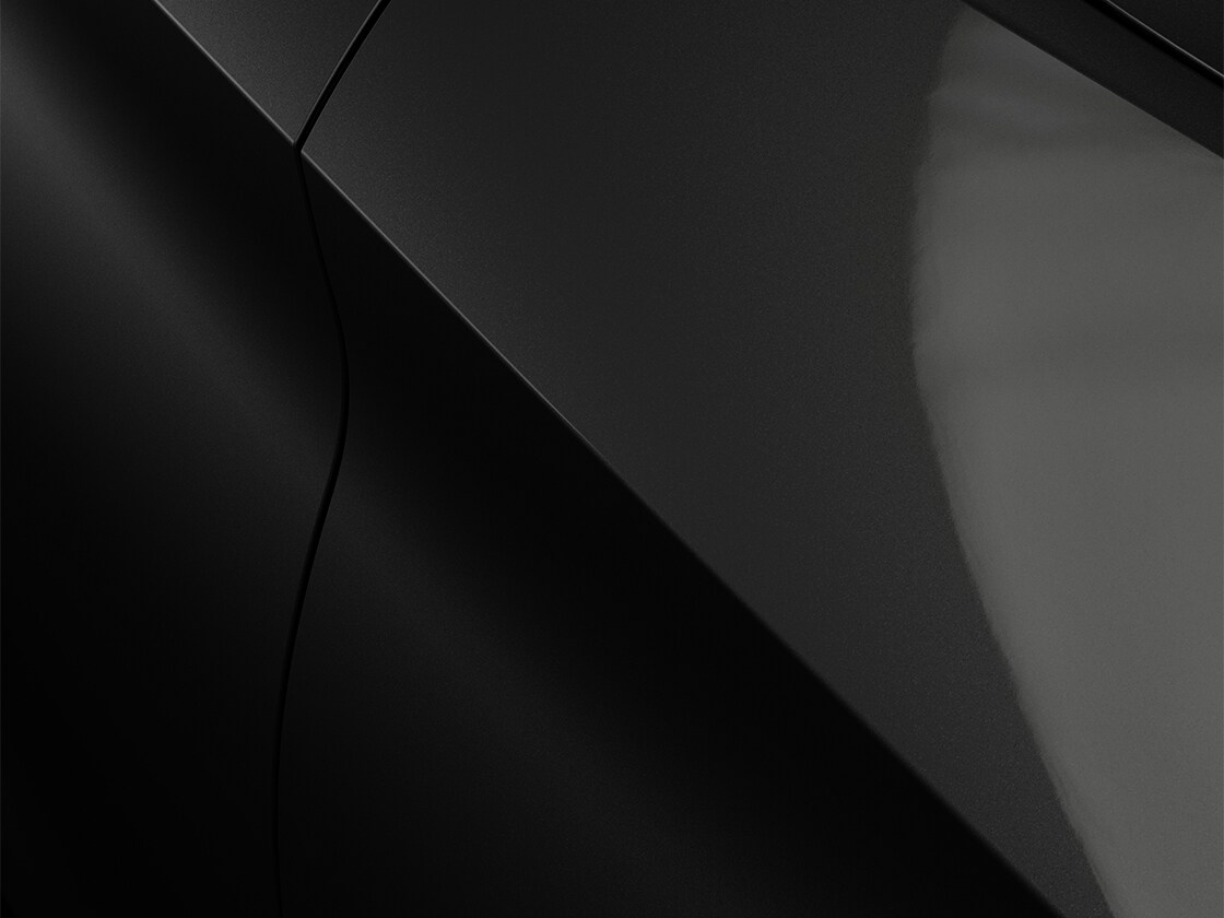 SEAT Leon in midnight black with a metallic finish, close up.