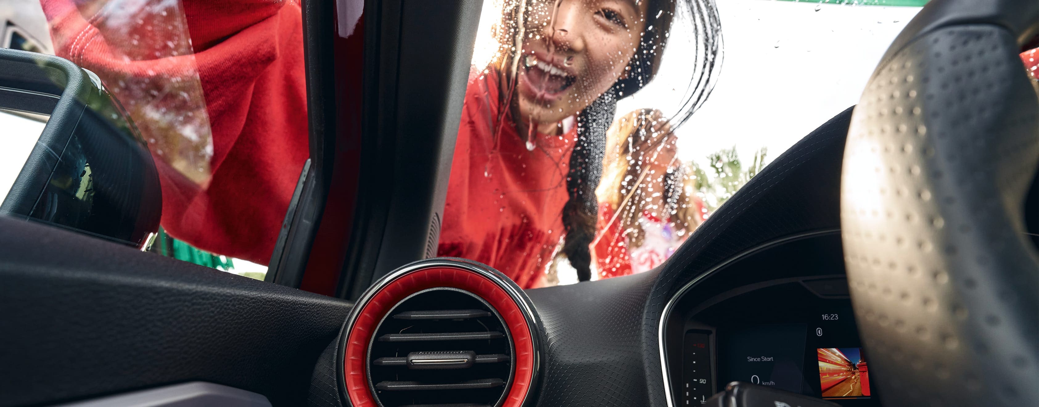 SEAT Ibiza interior view of a woman cleaning the windshield