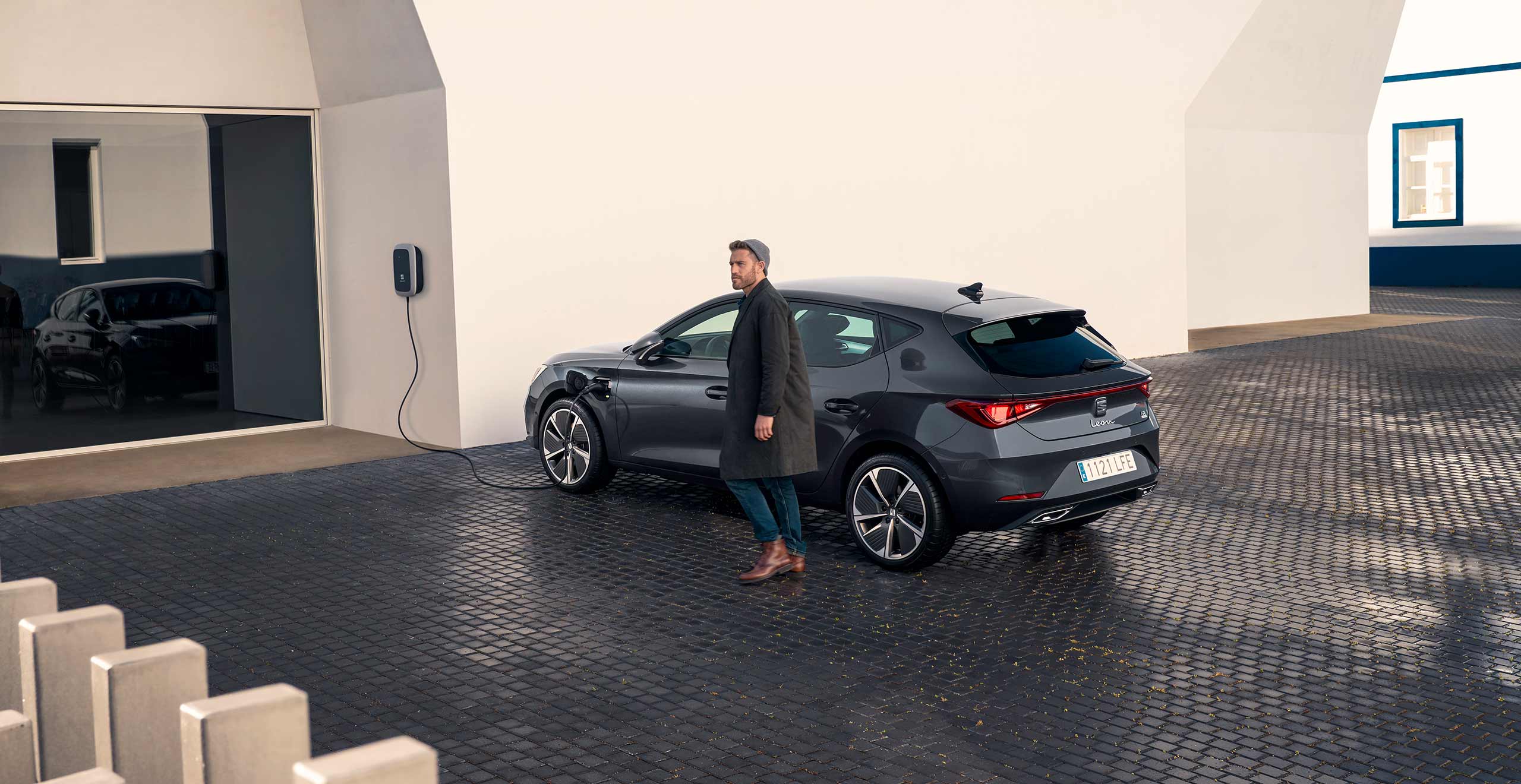 Man with new SEAT charge plug in at home