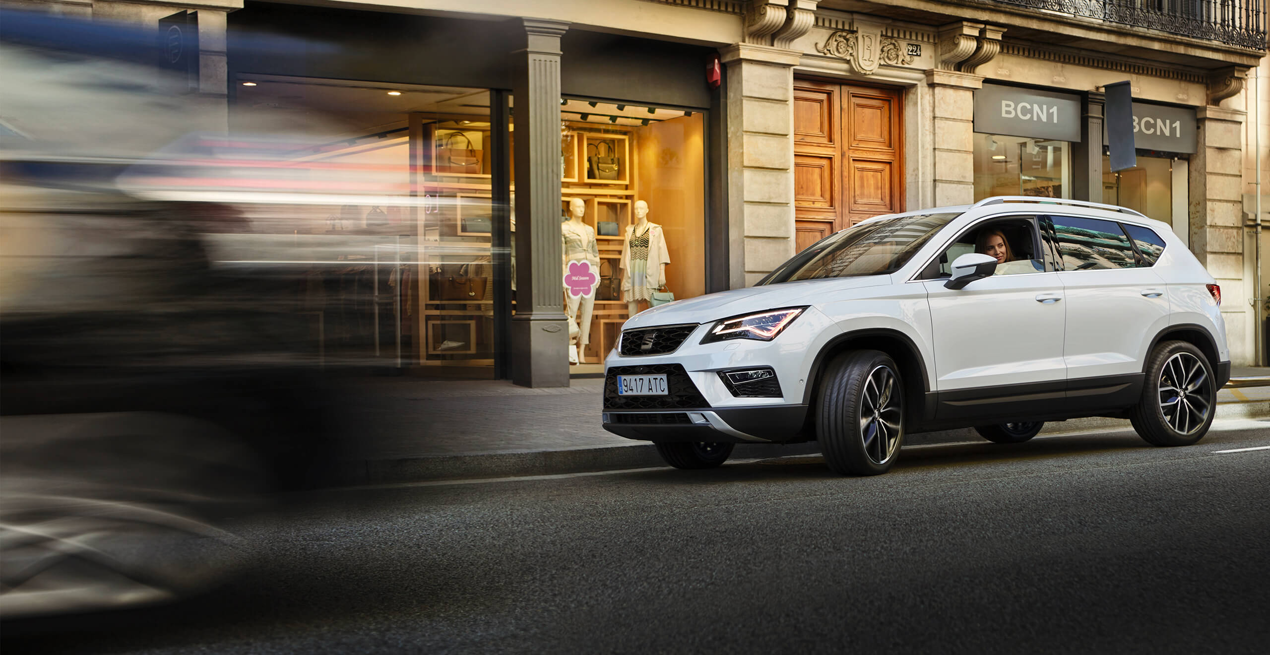 SEAT new car services and maintenance – white SEAT Ateca SUV driving in the city